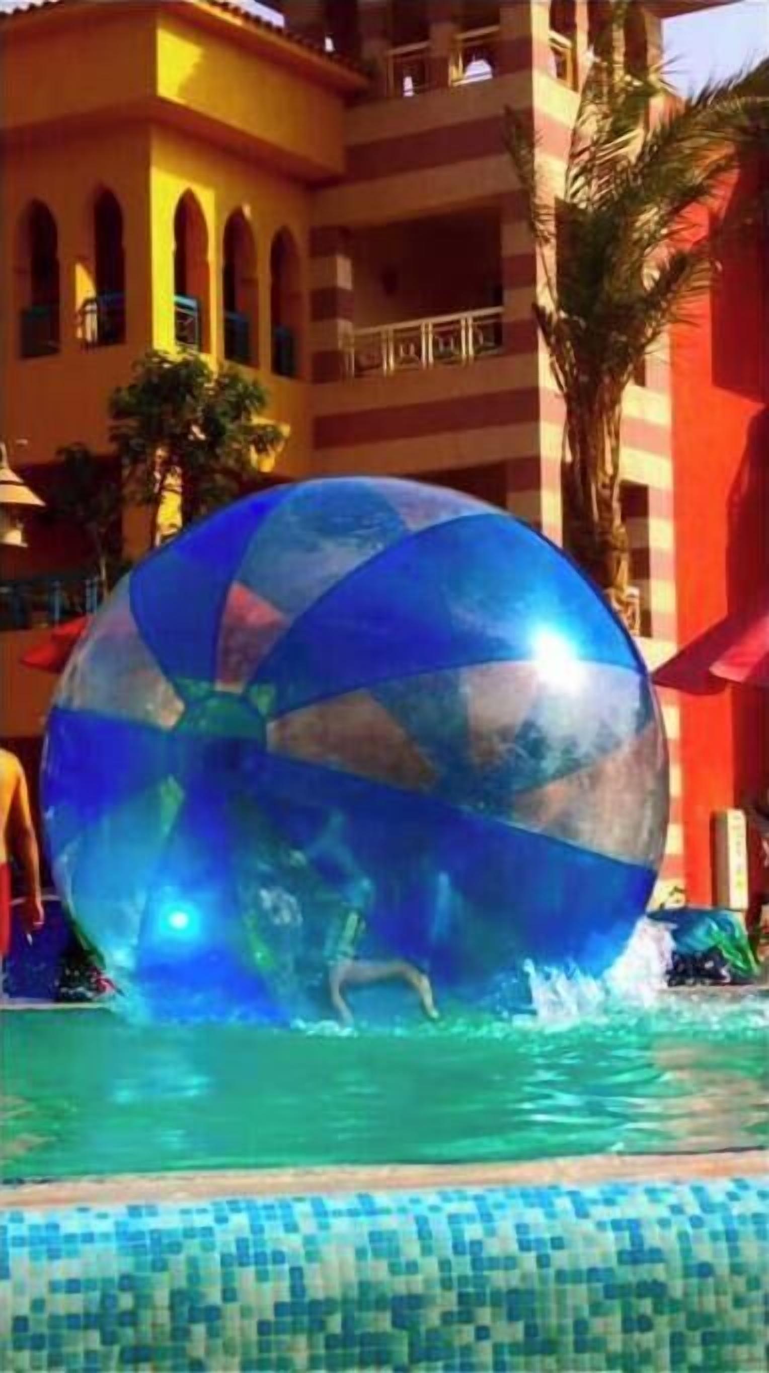 A water play area with a large transparent ball.