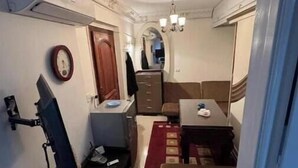 A compact living space with a kitchenette, a dining area, and a small seating area. - Amazing studio apartment gleem (Alexandria)