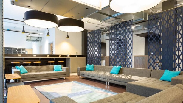 A modern lounge area with sofas, a coffee table, and pendant lighting. - Student Only Market Quarter (Bristol)