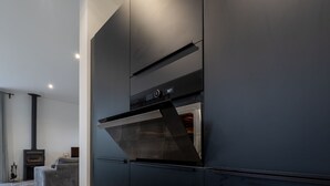A modern kitchen with a built-in oven and a sleek, dark cabinetry design. - Margaux Deluxe 8p - Four Bedroom Villa, Sleeps 8 (Salles)