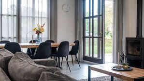 A modern living room with a dining area, large windows, and a fireplace. - Margaux Deluxe 8p - Four Bedroom Villa, Sleeps 8 (Salles)
