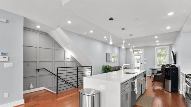 A modern kitchen with a central island, a staircase, and a dining area. - Renovated 2Level Flat+H St+Laundry (Washington)