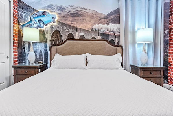 Enjoy a cozy night's sleep in this elegantly styled bedroom with a plush headboard and crisp white linens. A unique vintage car mural adds character, while the warm glow from bedside lamps creates a welcoming ambiance.