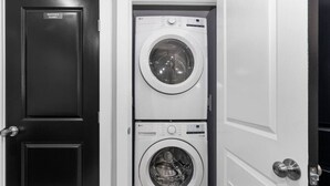 A laundry room with two stacked washing machines and a door labeled "Janitor's Closet". - New DC Unit+Prime Location+2BR+Private Parking (Washington)