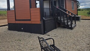 A small, single-story building with a porch and a bench. - Private cabin for two
National Forest and outdoor fireplace 
Near Hot Springs (Glenwood)
