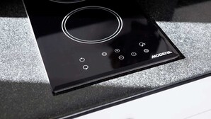 A black induction cooktop with a control panel and the brand name 'MODENA'. - Cute 1BR Villa 5Mins Walk to Eat Street Seminyak (Seminyak)