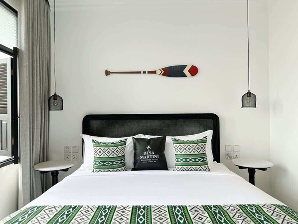 A hotel room with a bed, two bedside tables, a headboard, and a decorative item on the wall.