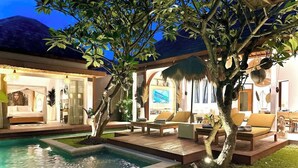 A poolside area with outdoor seating and a view of the interior. - Tropical Cozy 4BR Villa Pacha Seminyak Up to 12pax (Seminyak)