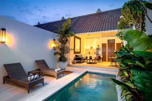 A poolside area with lounge chairs, a small pool, and a dining area with a table and chairs. - Walk around Seminyak Petitenget from 1BR PoolVilla (Kerobokan Kelod)