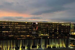 A modern hotel with a prominent 'NUWA' sign, featuring a glass facade and vertical light strips. - Luxurious Penhouse Cross City of Dreams OKADA SOLAIRE MOA (Paranaque)