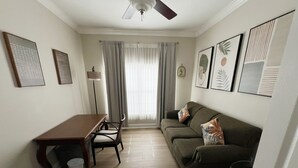 A compact living space with a dining table, a sofa, and a ceiling fan. - Luxury Townhome on reunion resort (Kissimmee)