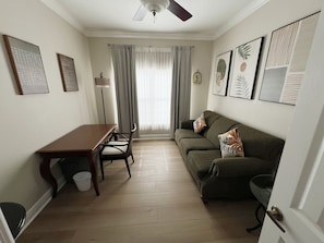A compact living space with a dining table, a sofa, and a ceiling fan. - Luxury Townhome on reunion resort (Kissimmee)