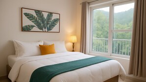 A neatly made bed with white and green bedding, a yellow pillow, and a framed plant artwork above it. - Pennylane Hotel (Rishikesh)