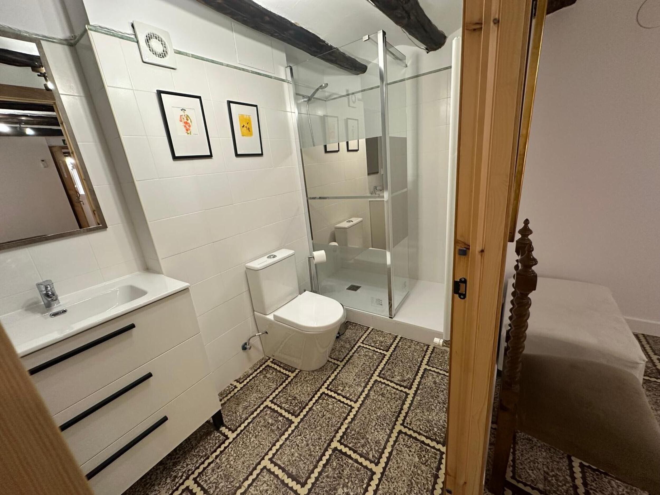 A bathroom with a toilet, sink, and shower.