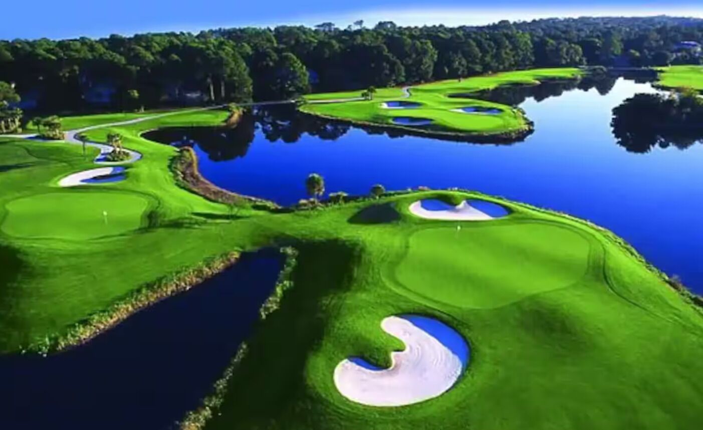 A golf course with multiple bunkers and water hazards.