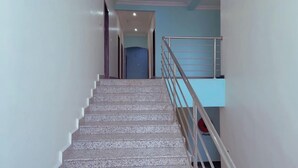 A staircase with a metal railing leading to a landing.