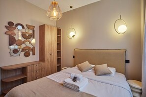 A modern hotel room with a large bed, wooden furniture, and unique wall decor.