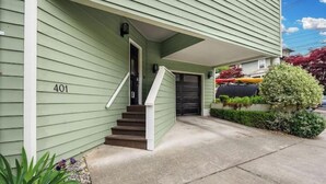 A green two-story house with a front porch, a staircase, and a mailbox. - QAnne Hideaway•PrivateDeck•Jacuzzi Tub•CA King•BBQ (Seattle)