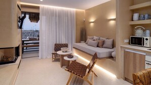 A modern living room with a sofa, two chairs, a small table, and a kitchen area with a microwave. - Numa Villas - Villa Taupe, by Estia (Malia)