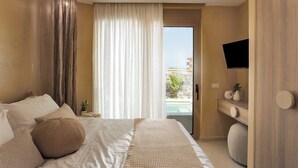 A bedroom with a bed, a TV, a window with curtains, and a view of the outside. - Numa Villas - Villa Taupe, by Estia (Malia)
