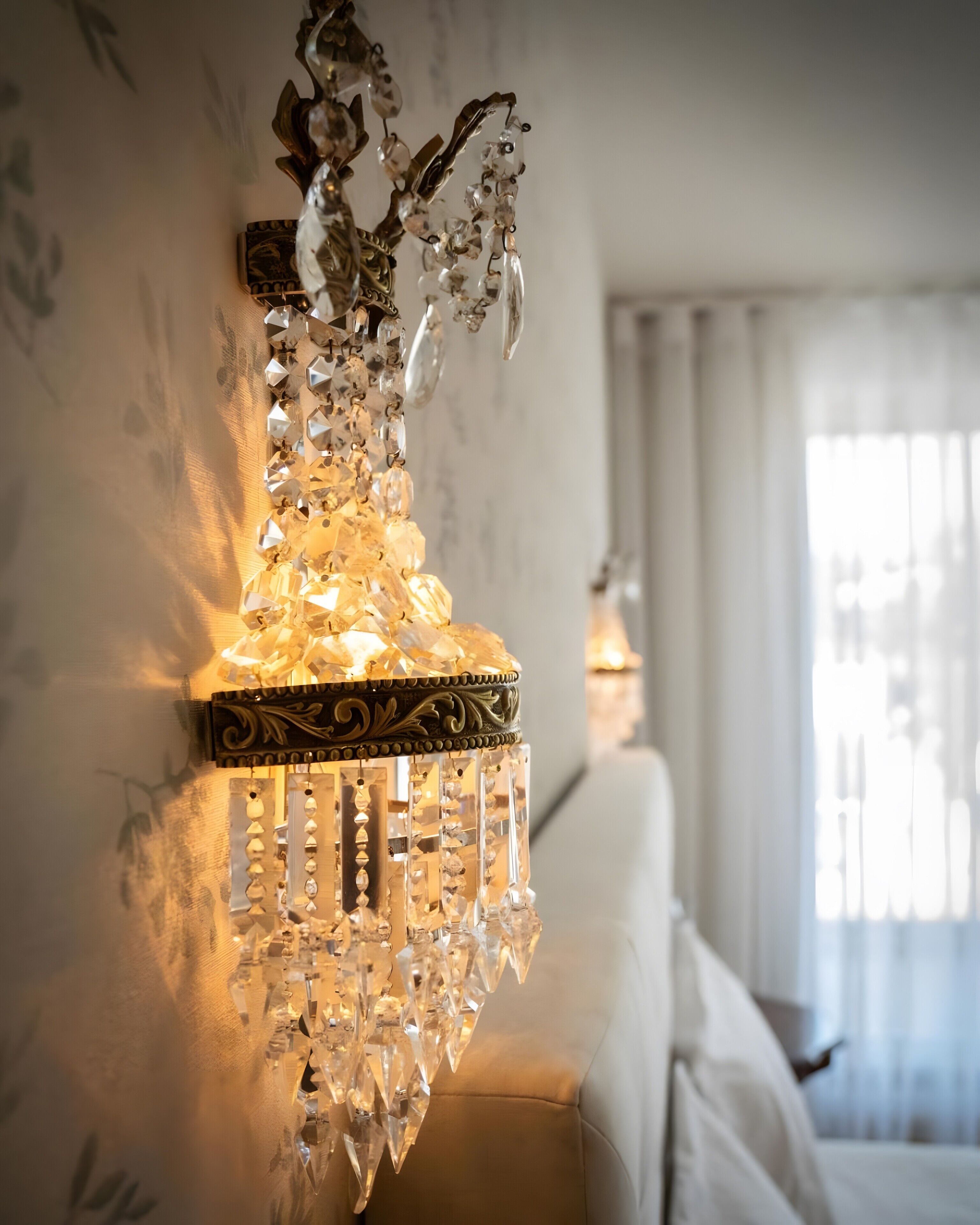 A chandelier with crystal decorations and a wall-mounted design.