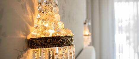A chandelier with crystal decorations and a wall-mounted design.