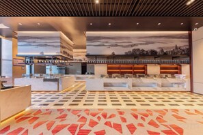 A hotel lobby with a check-in counter, seating area, and a patterned carpet. - Bai an Hotel (Chongqing)