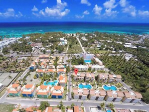 A resort with multiple buildings, swimming pools, and a view of the ocean. - Rooftop Penthouse Stargazing Walk 2 Beach & Fun (Punta Cana)