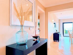A modern interior with a console table, a decorative vase, and a model sailboat. - Your Private Pool, Marina Resort & Grounds (Punta Cana)