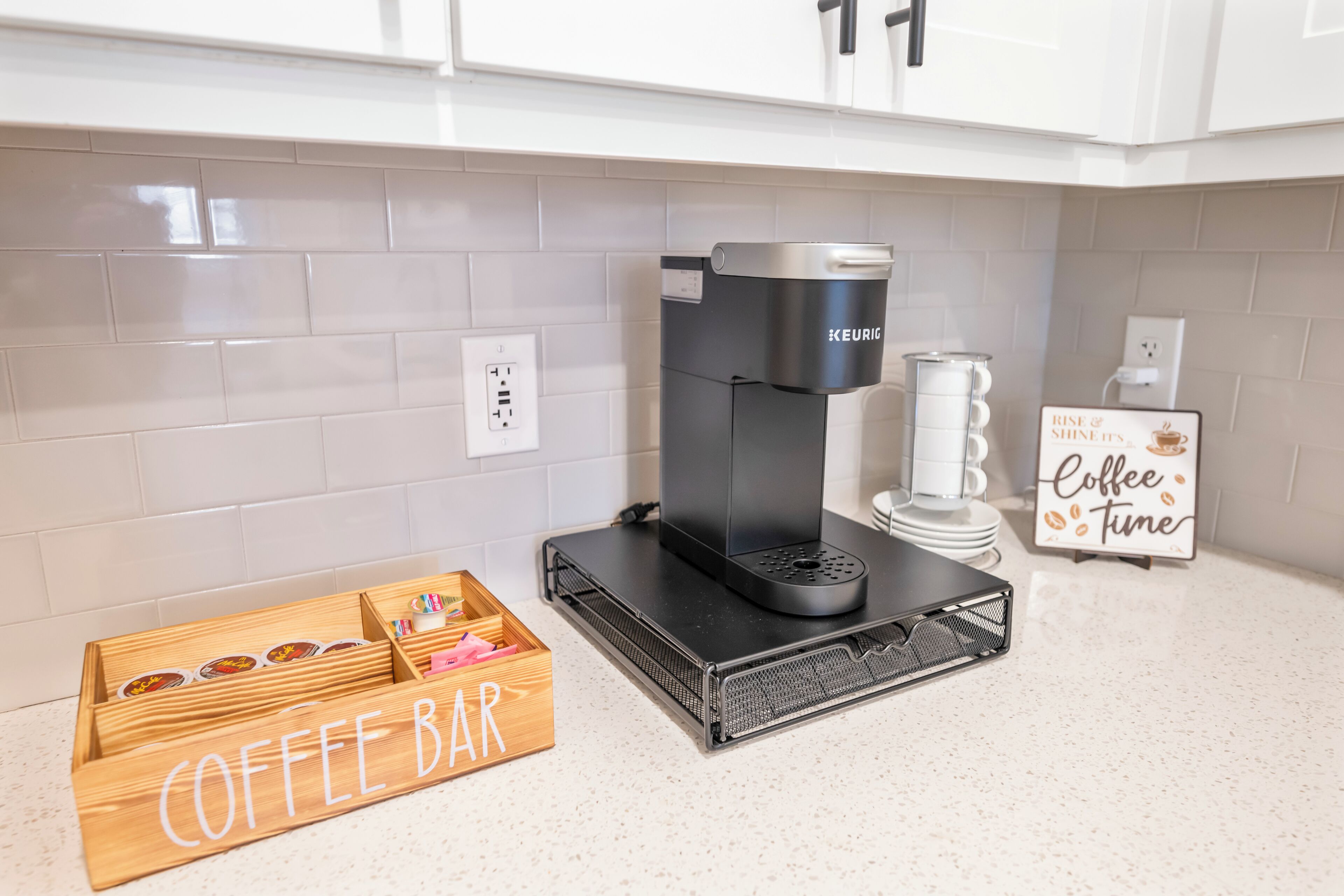 A kitchen with a coffee machine, a coffee bar, and a sign that says 'Coffee Time'.
