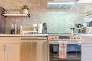 A modern kitchen with a built-in oven, a dishwasher, and a stove.