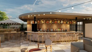 A modern bar area with a curved counter, multiple seating options, and a variety of bottles displayed on shelves. - Hyatt Centric Queretaro (Querétaro)