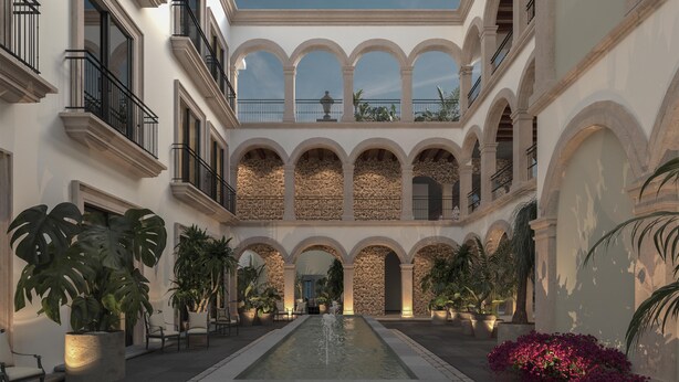 A courtyard with a central water feature, stone walls, and multiple balconies. - Hyatt Centric Queretaro (Querétaro)
