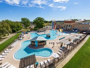 A swimming pool area with multiple pools, lounge chairs, and a bar area. - Anchors Away Getaway: Clean, sleeps 10, family fun, waterpark, fully stocked! (Spirit Lake)