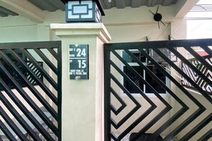 A gated entrance with a sign indicating room numbers 24 and 15. - Amplayo Apartelle Studio Type Unit (Cagayan De Oro)