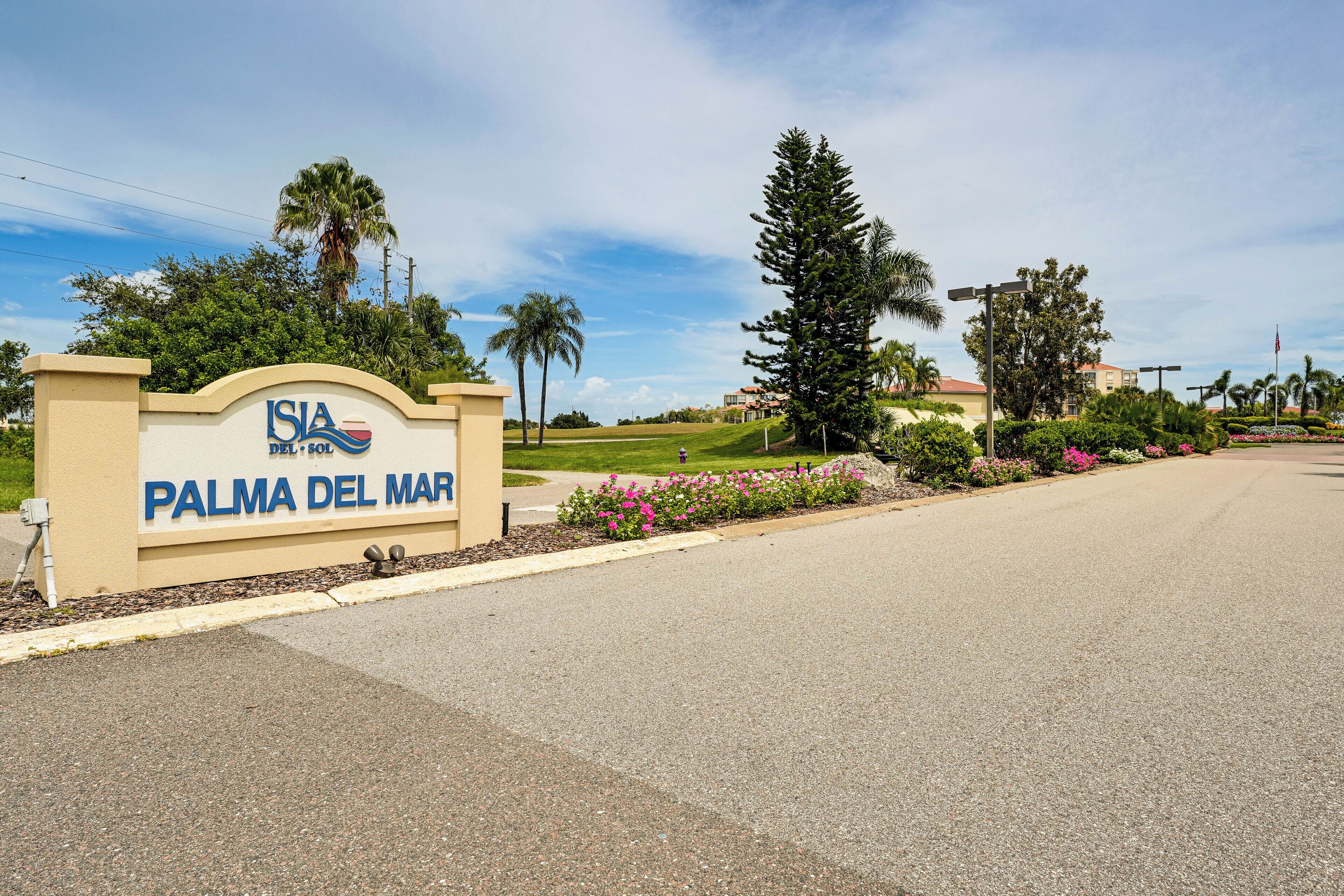 A sign for "ISLA DEL MAR PALMA DEL MAR" with a landscaped entrance and palm trees.