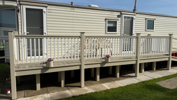 A mobile home with a porch, two windows, and a chimney. - Seaside Getaways - Happy Days Chapel st Leonards (Skegness)