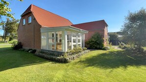 A two-story house with a red-tiled roof and a conservatory with glass doors. - 3 bedroom gorgeous home in Ulfborg (Ulfborg)
