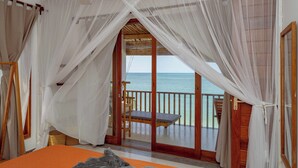 A room with a bed, a wooden bench, and a balcony with a view of the sea. - 3 Apartment, 4-Bedroom Beach Villa Property with Private Pool Jambiani, Zanzibar (Jambiani)