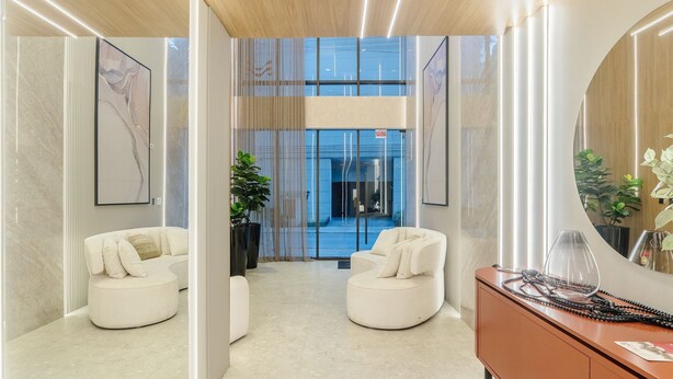 A modern hotel lobby with two white sofas, a wooden cabinet, and a large mirror. - Well-equipped Apartments 100m From the Beach - EVR (Porto Belo)