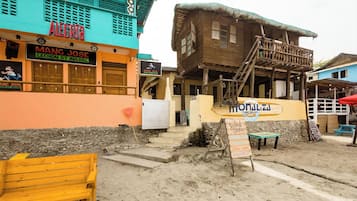 A beachside building with a sign for 'Mangal Jose Lechon at Inasal' and another for 'Monalisa Surf Beach'.