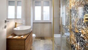 A modern bathroom with a large white sink, wooden vanity, and a glass shower enclosure with a leaf pattern. - CHARME HOLIDAYS PUCCINI (Rome)