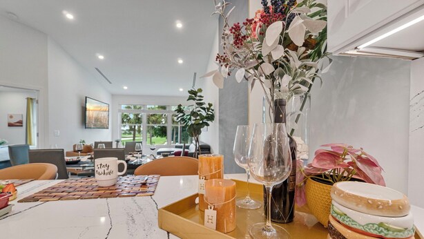 A dining area with a marble table, candles, a vase with flowers, and a tray with food items. - NEW! Golf View Getaway Condo, 3 bedrooms, 2 bathrooms, heated pool (Naples)