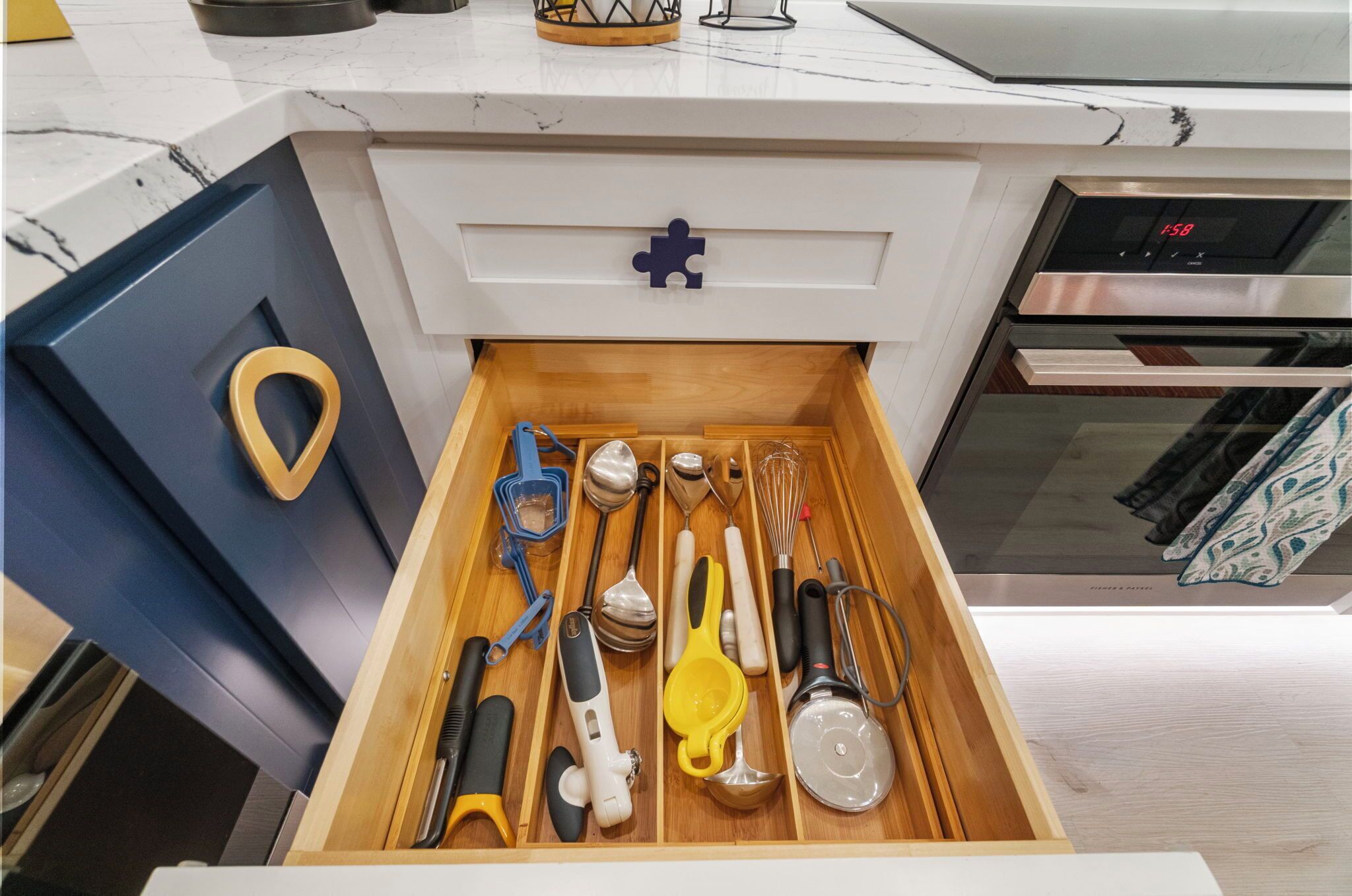 A kitchen drawer with various utensils neatly organized.