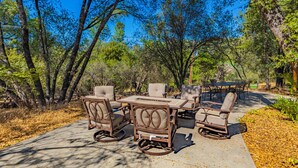 An outdoor patio with a dining set and chairs.