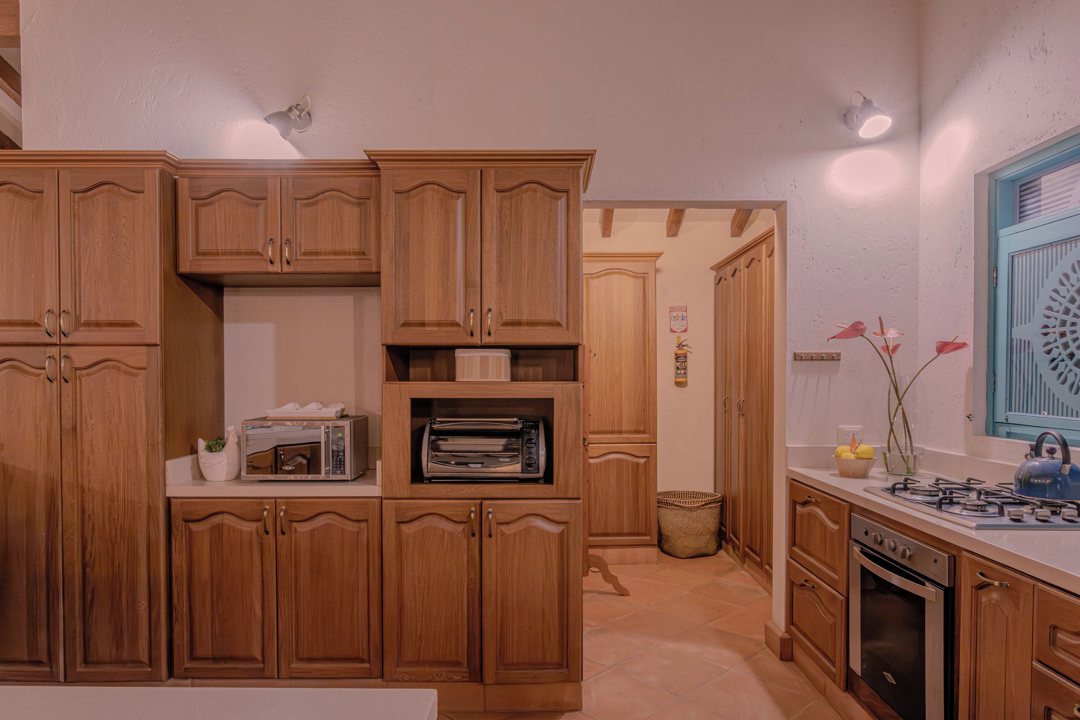 A kitchen with wooden cabinets, a built-in oven, a microwave, and a gas stove.