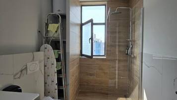 Standard Apartment | Bathroom | Shower, hair dryer, towels, soap