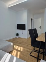 Standard Apartment | Living area | 40-inch Smart TV with cable channels