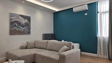 Standard Apartment | Living area | 40-inch Smart TV with cable channels