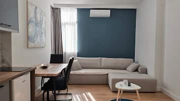 Standard Apartment | Living area | 40-inch Smart TV with cable channels